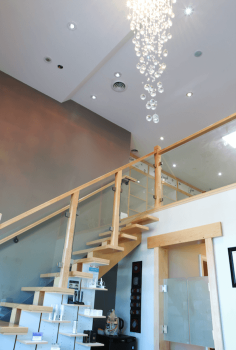 Leslie Med Spa — modern staircase, crystal chandelier, product displays